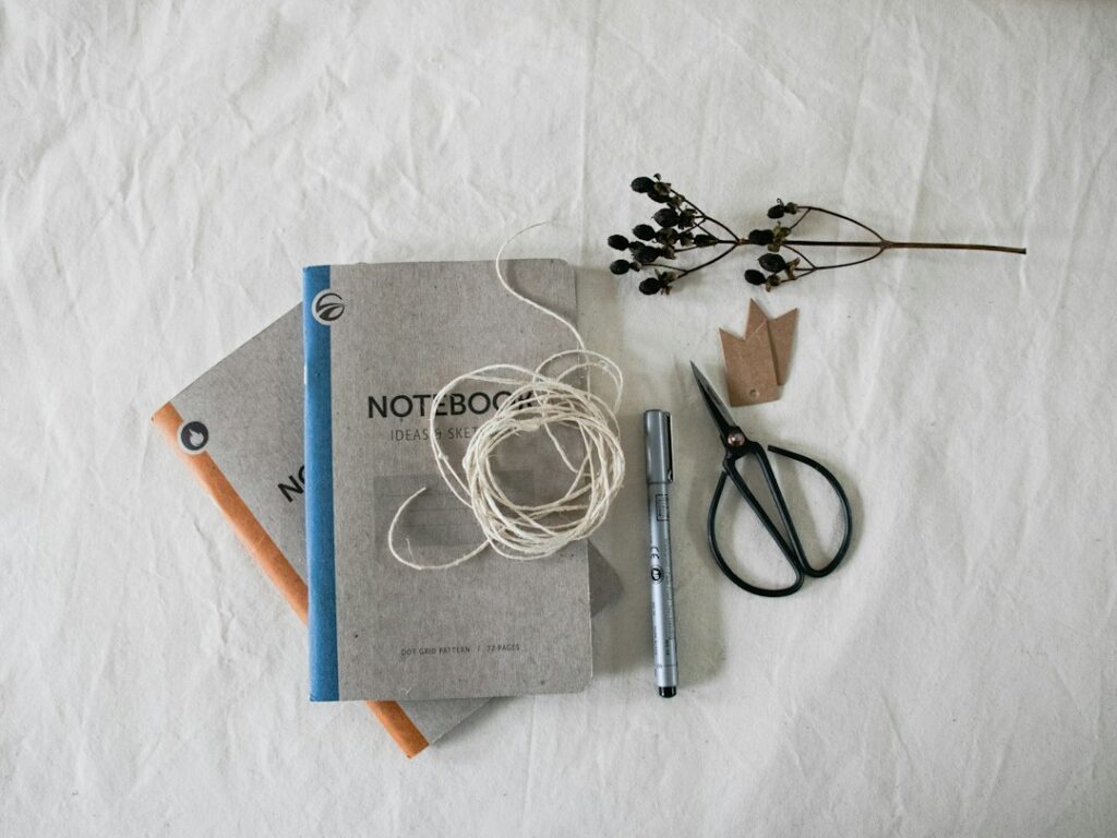 Illustrative desktop with book craft materials, not a specific bookbinding awl product