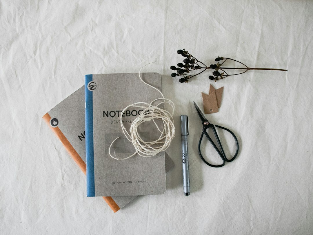 Illustrative desktop with book craft materials, not a specific bookbinding awl product