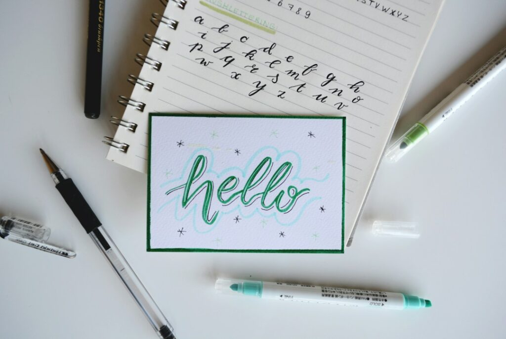 Brush lettering and art pens arranged on a creative desk