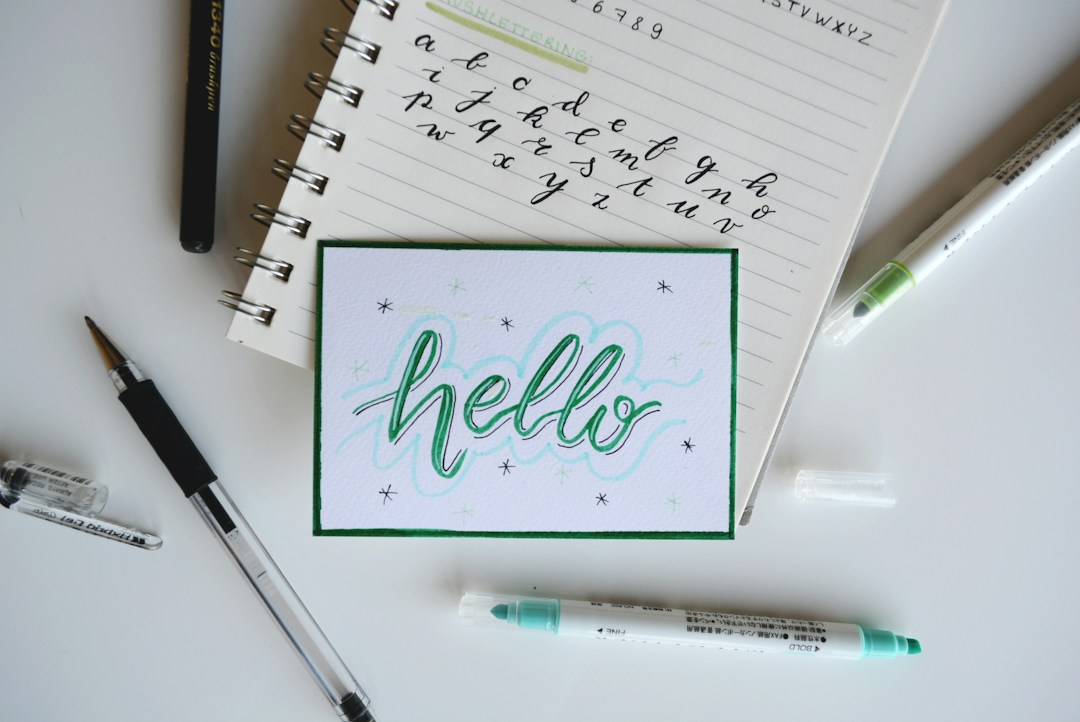Brush lettering and art pens arranged on a creative desk
