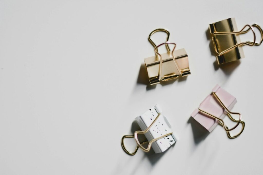 Gold metal bulldog clips used as stationery accessories