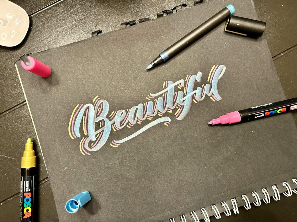 Illustrative lettering on paper, not a specific marker paper product