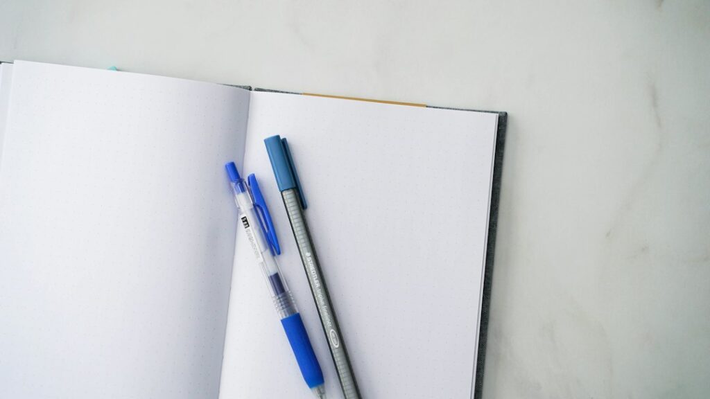 Illustrative notebook and pen photograph, not a Pilot FriXion product photograph