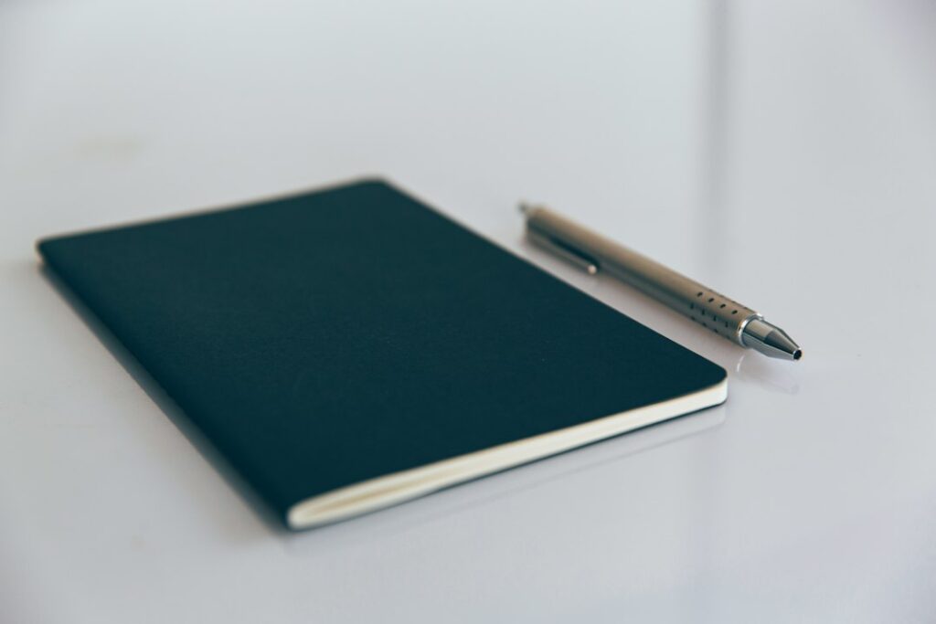 Notebook with writing instrument, illustrating notebook accessories rather than a pen-loop product