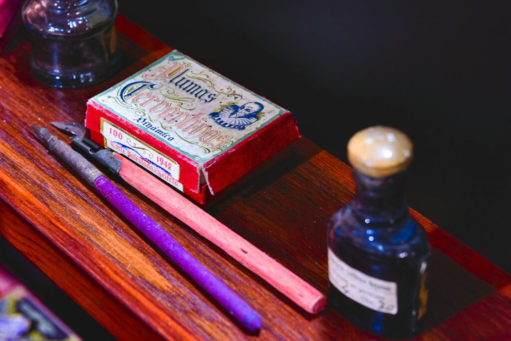Illustrative vintage writing ink tools on a table, not an ink bottle storage product