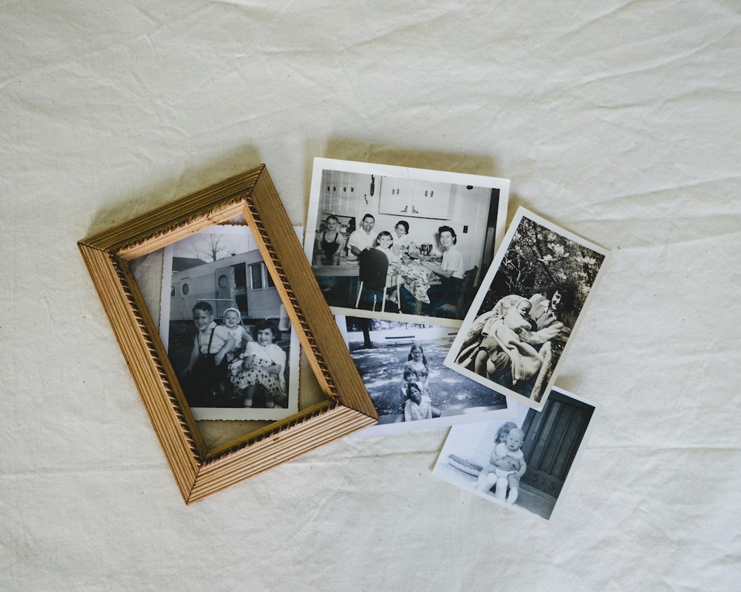 Old family prints on a surface, illustrative image not a particular archival sleeve product