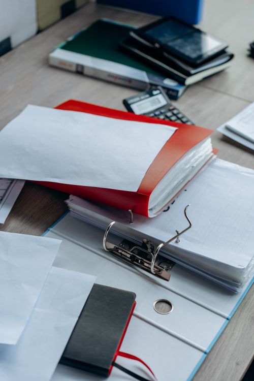 Binders and office documents arranged on a tidy desk