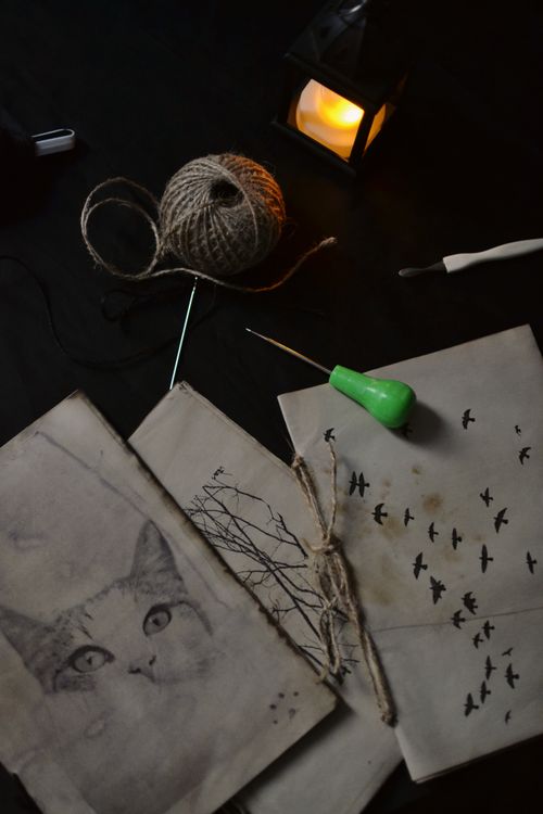 Bookbinding tools and materials arranged on a craft table