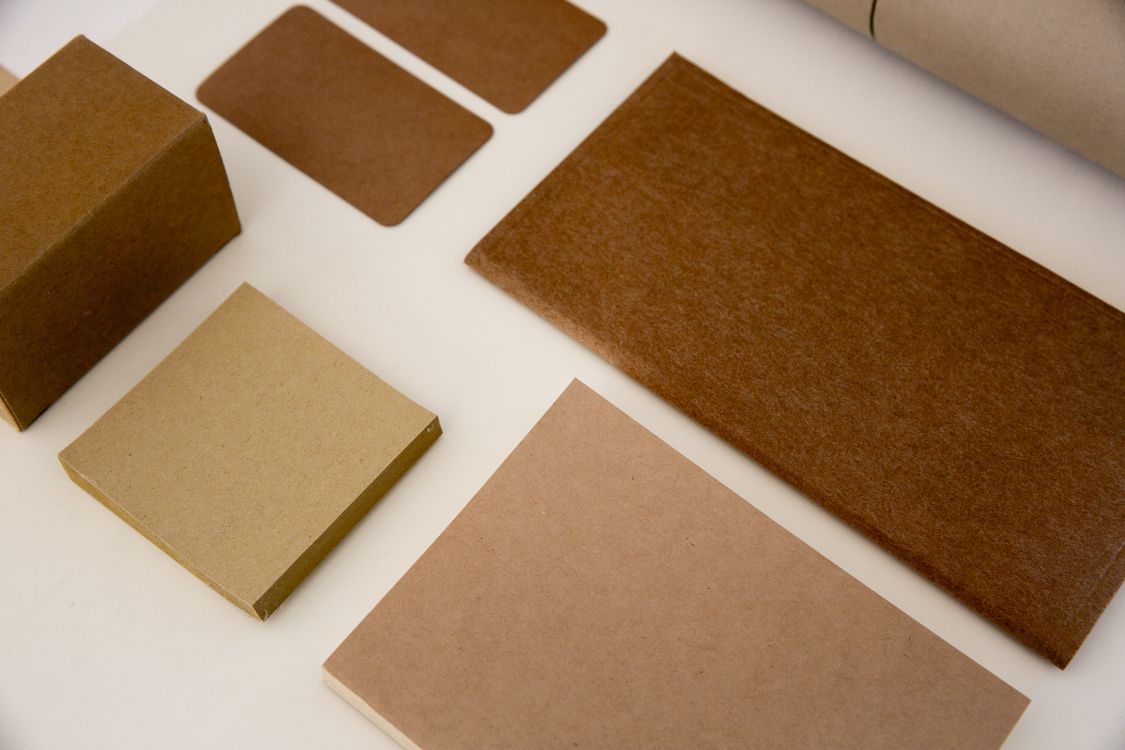 Assorted kraft and cardstock papers arranged on a clean surface