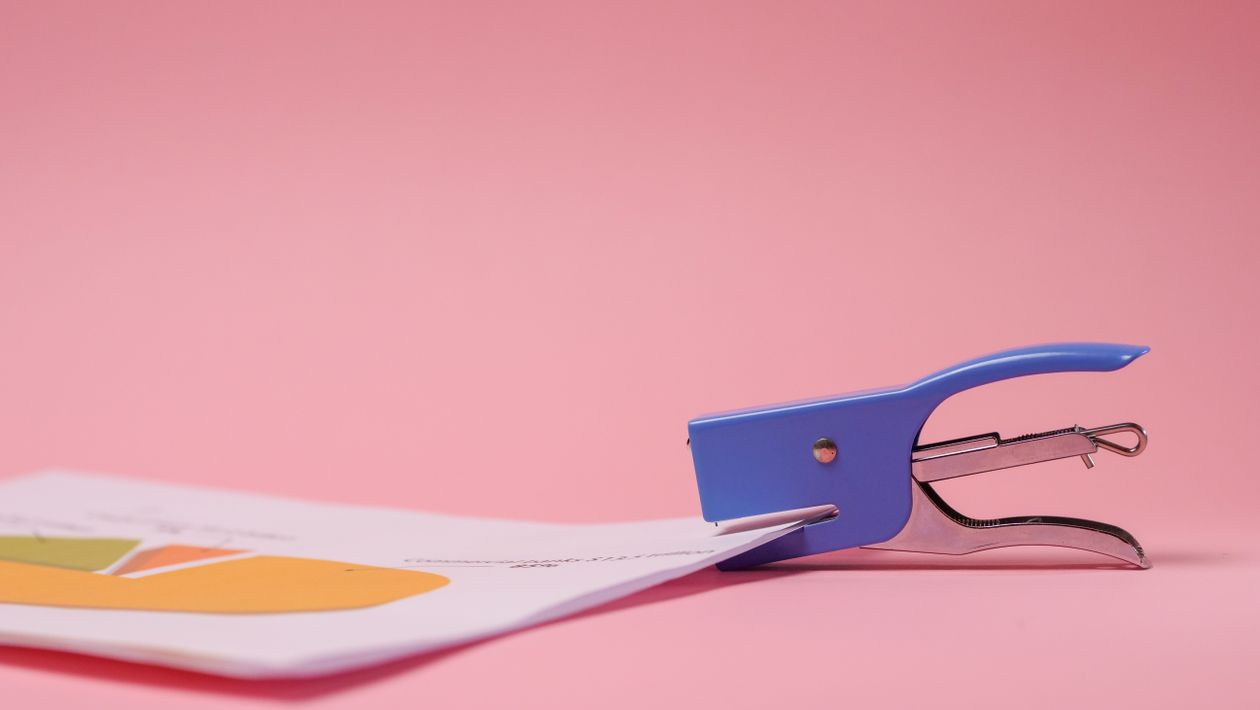 Stapler fastening colourful office papers