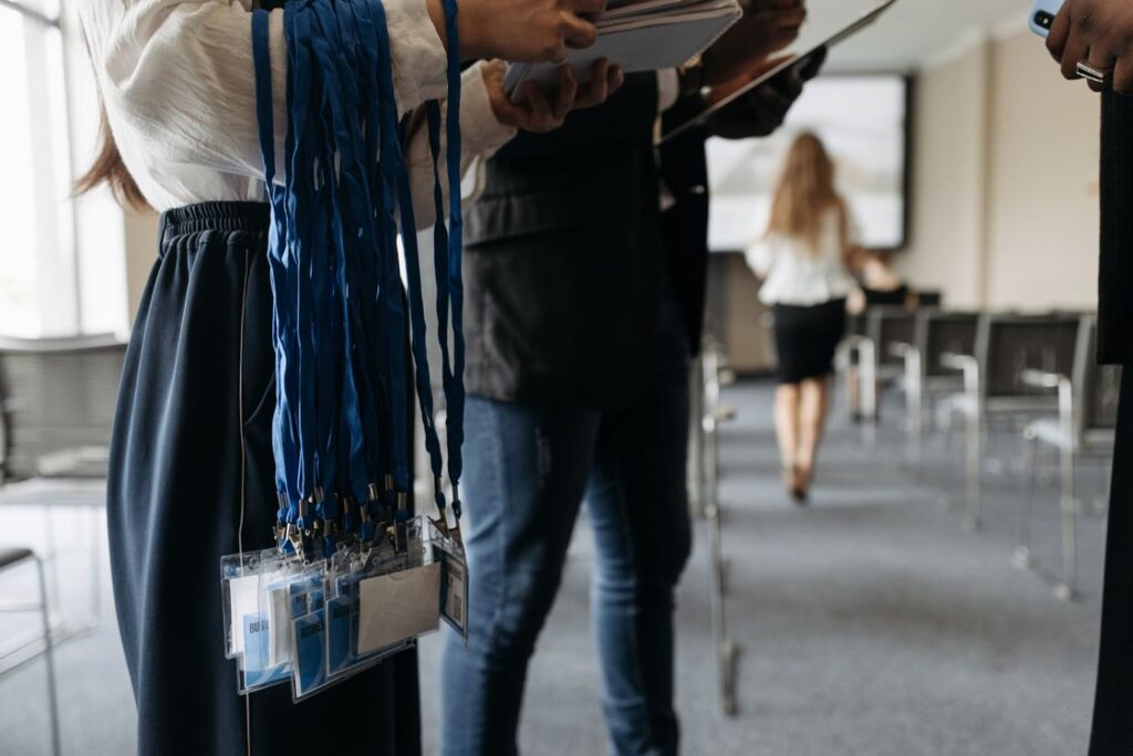Conference attendees with name badges and lanyards