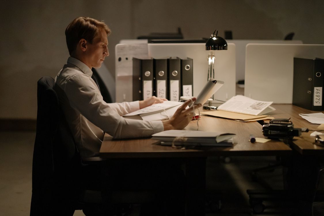 Office worker reviewing organized case files and folders at a desk