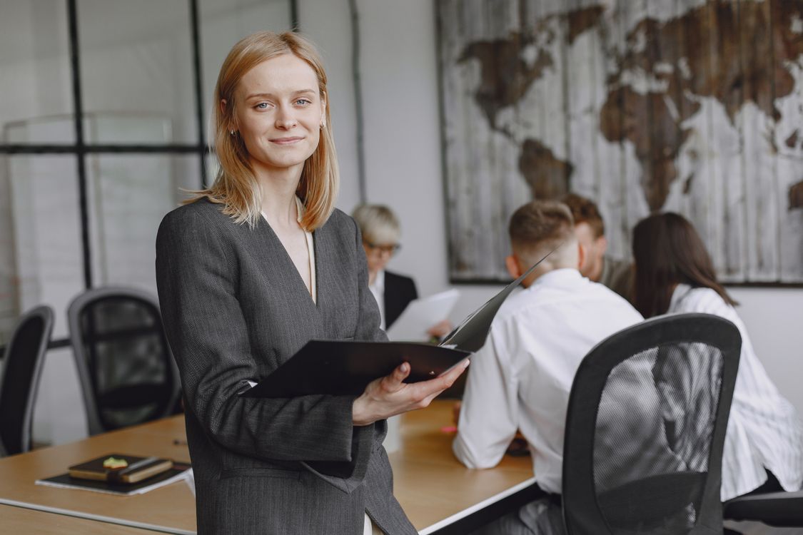 Business professional holding a folder during a meeting
