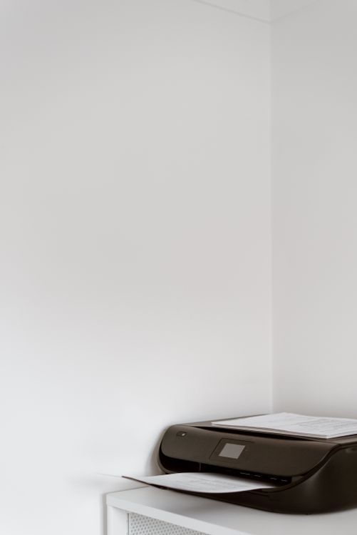 Modern office printer with clean white paper ready for printing