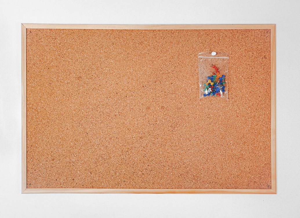 Colorful push pins on a cork board