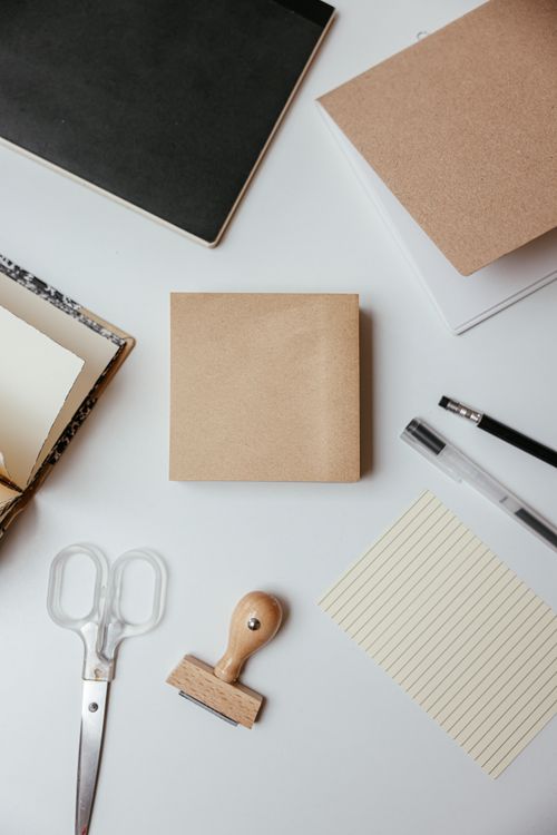 Scissors and office stationery arranged on a clean white desk