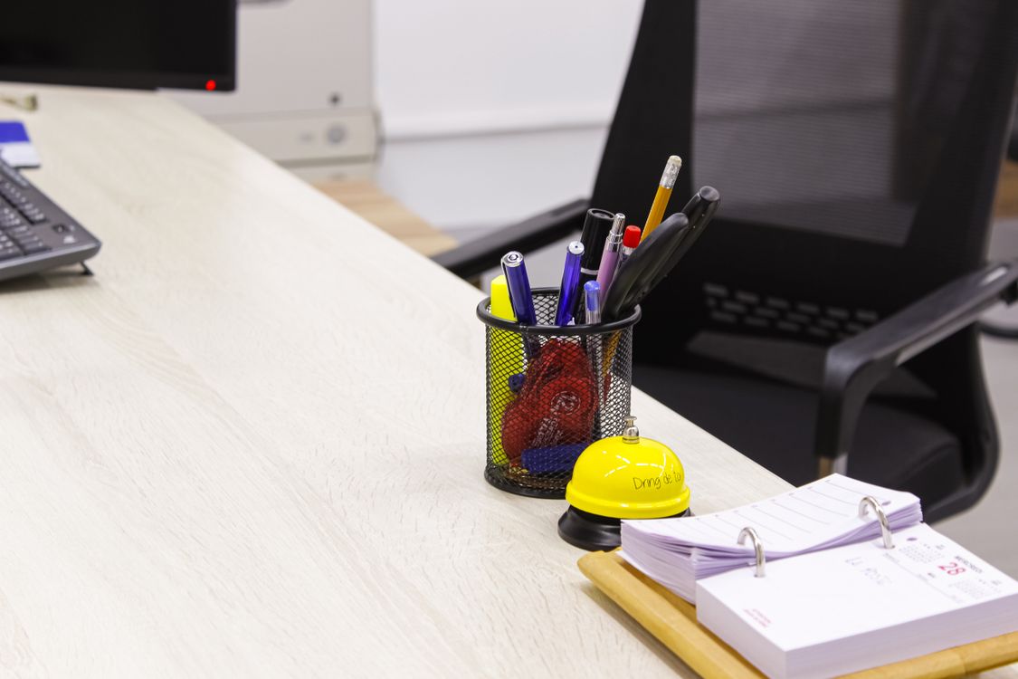 Tidy office desk with a pen holder and supplies