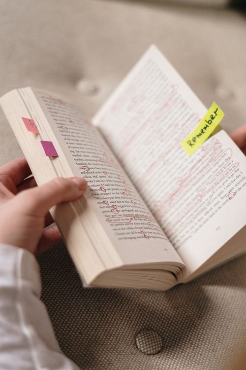 Open book with colorful sticky notes and page markers