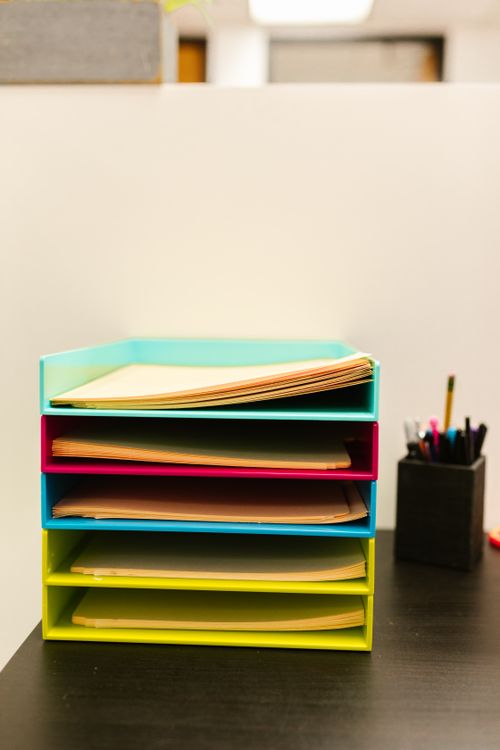 Stacked paper trays holding office documents