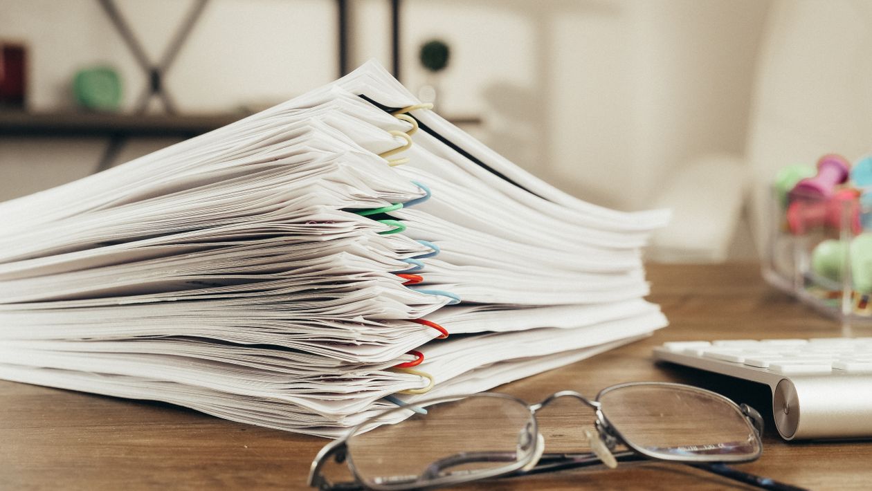 Office documents neatly clipped together on a desk
