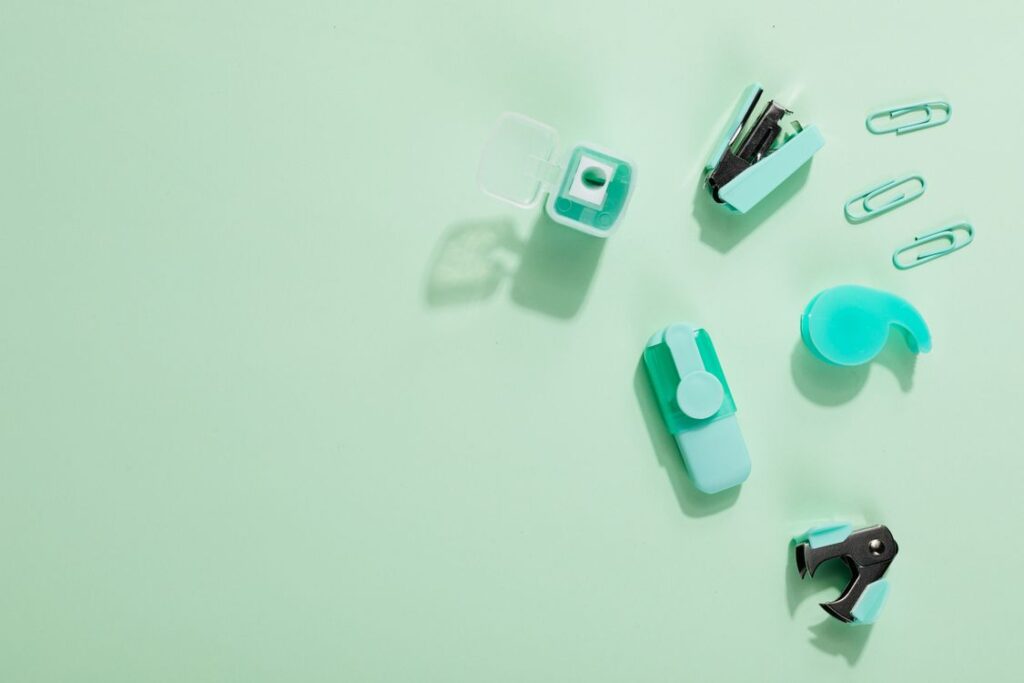 Mint green office accessories including a staple remover and stapler