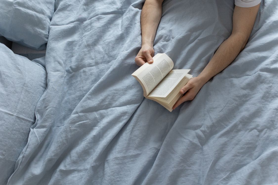 Person reading comfortably in bed