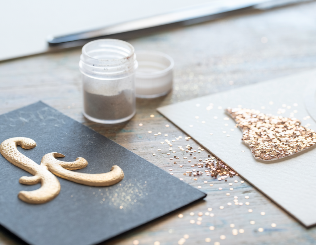 AI-generated editorial illustrative photograph comparing heat embossing powder and loose glitter